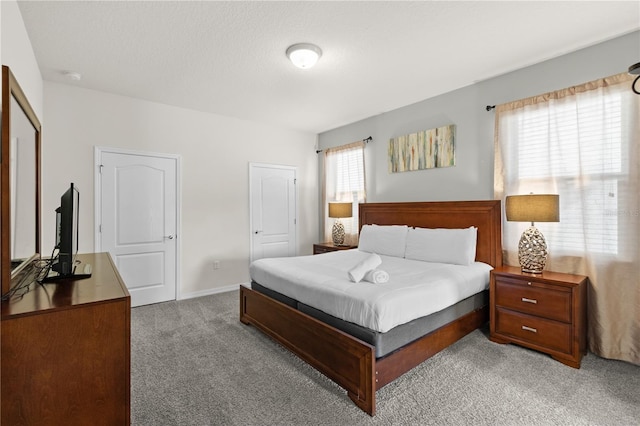 carpeted bedroom featuring a textured ceiling