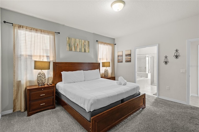 carpeted bedroom with ensuite bath