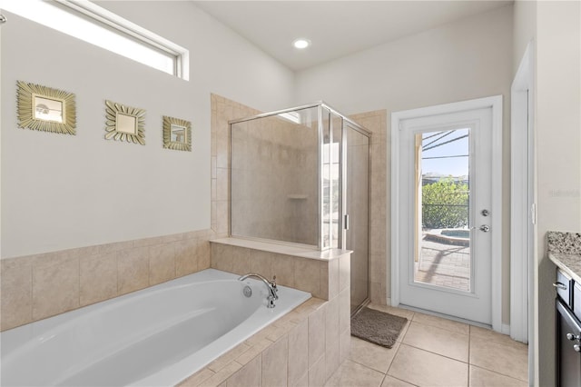 bathroom featuring tile patterned flooring, vanity, and plus walk in shower