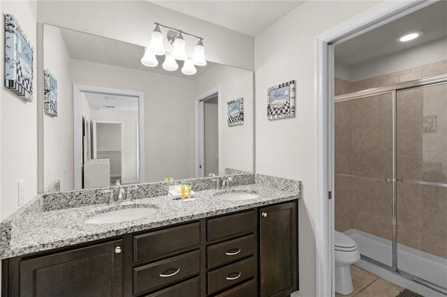 bathroom with tile patterned flooring, vanity, toilet, and an enclosed shower