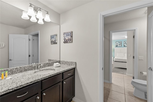 bathroom featuring tile patterned floors, vanity, toilet, and a textured ceiling