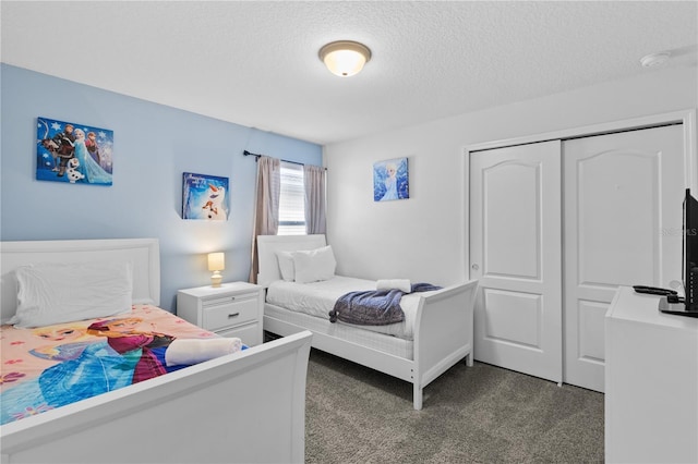 carpeted bedroom with a closet and a textured ceiling