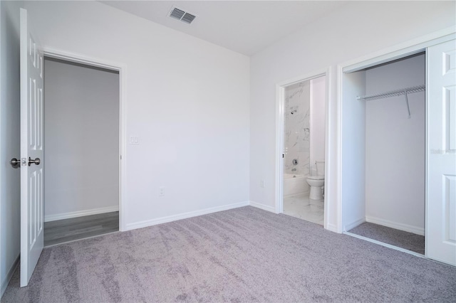 unfurnished bedroom featuring carpet and a closet