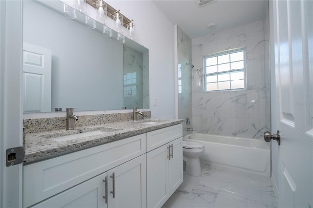 full bathroom with vanity, tiled shower / bath combo, and toilet