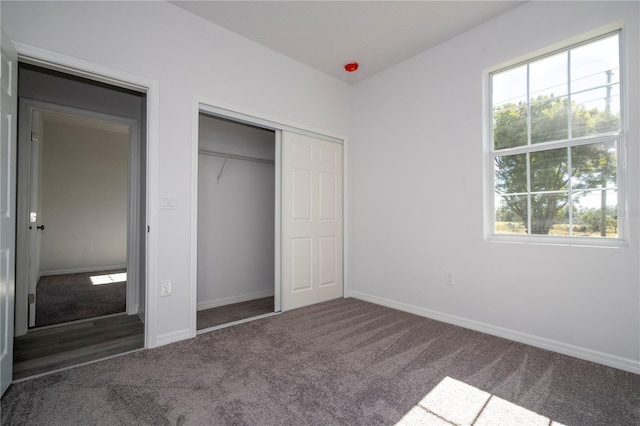 unfurnished bedroom with dark colored carpet