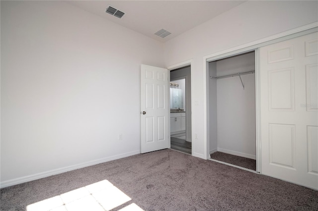 unfurnished bedroom with carpet floors and a closet