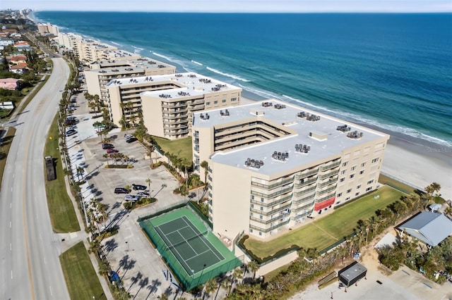 bird's eye view featuring a water view and a beach view