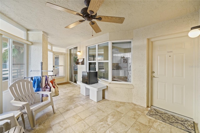 sunroom / solarium with ceiling fan