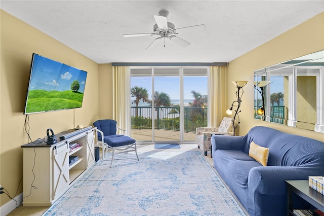 carpeted living room featuring ceiling fan and a healthy amount of sunlight