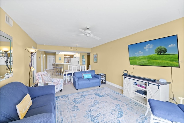 carpeted living room with ceiling fan