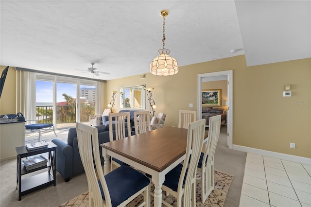 tiled dining space featuring ceiling fan and a textured ceiling