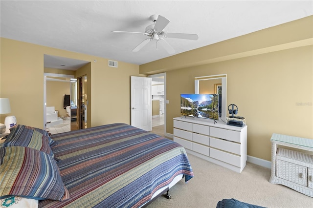 carpeted bedroom featuring ensuite bathroom and ceiling fan