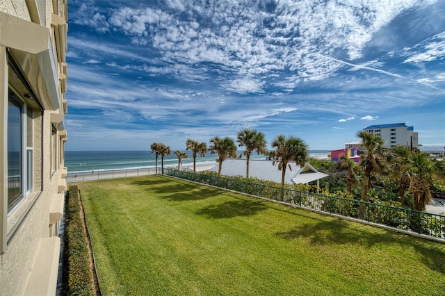 view of yard with a water view and a beach view