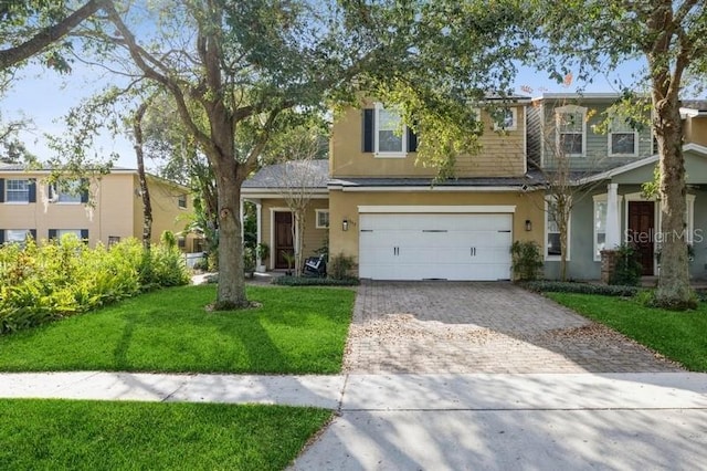 view of front of home featuring a garage and a front yard