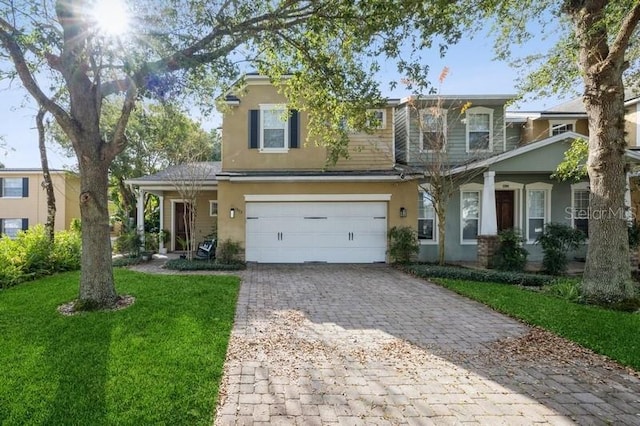 view of front of property with a front yard and a garage