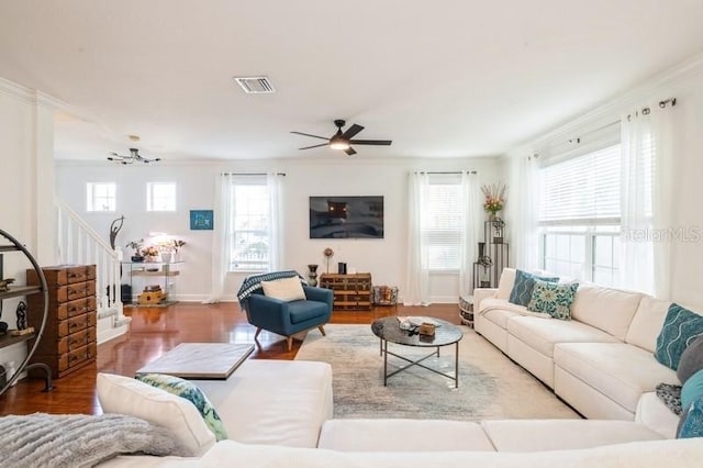 living room with hardwood / wood-style floors, ceiling fan, and ornamental molding