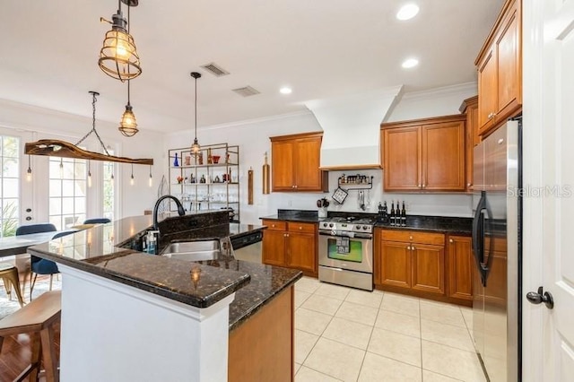 kitchen with ornamental molding, stainless steel appliances, hanging light fixtures, and premium range hood