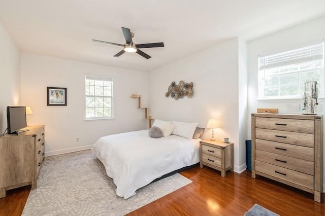 bedroom featuring ceiling fan and dark hardwood / wood-style floors