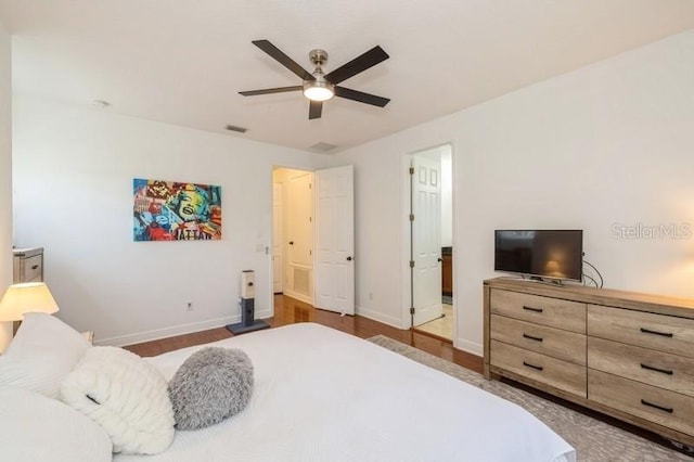 bedroom featuring ceiling fan and dark hardwood / wood-style floors