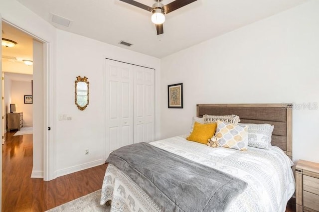 bedroom featuring dark hardwood / wood-style flooring, a closet, and ceiling fan