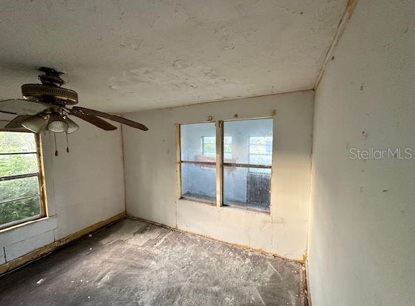 unfurnished room with ceiling fan