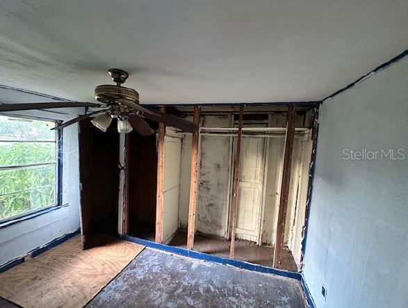 unfurnished bedroom with a closet and ceiling fan