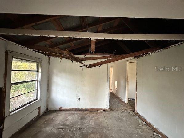 spare room featuring vaulted ceiling