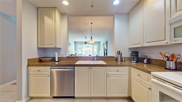 kitchen featuring sink, ceiling fan, light tile patterned floors, appliances with stainless steel finishes, and decorative light fixtures