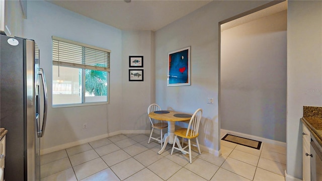 dining space featuring light tile patterned flooring