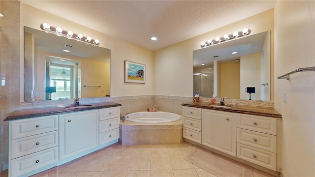 bathroom with separate shower and tub, tile patterned flooring, vanity, and a textured ceiling