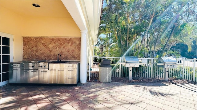 view of patio / terrace with a grill, sink, and an outdoor kitchen