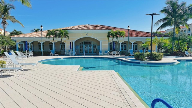 view of swimming pool featuring a patio and french doors