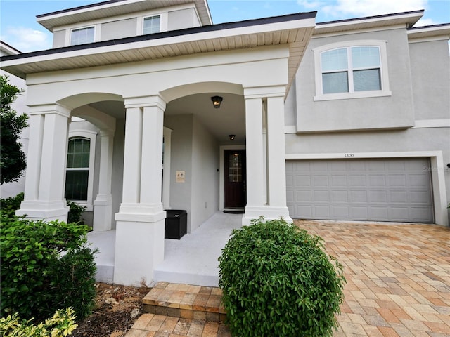 doorway to property with a garage