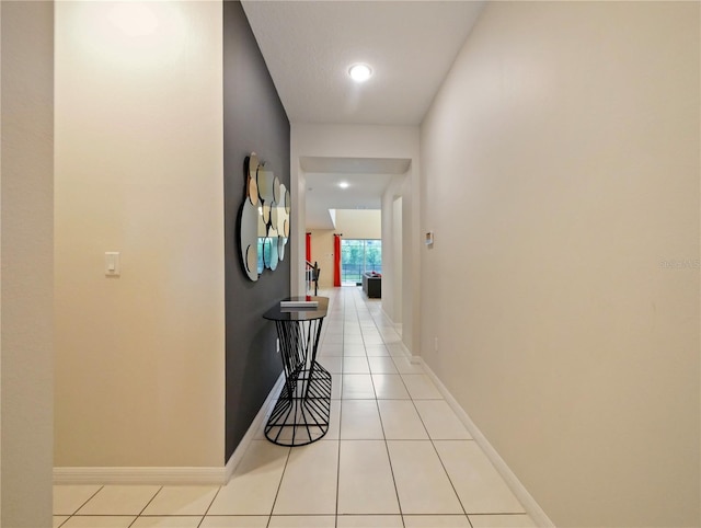 hall featuring light tile patterned flooring