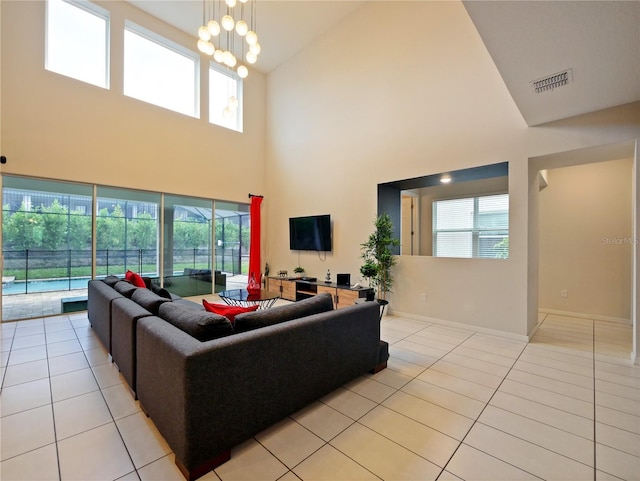 living room with light tile patterned floors, high vaulted ceiling, and a wealth of natural light