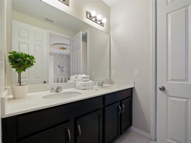 bathroom with tile patterned flooring and vanity