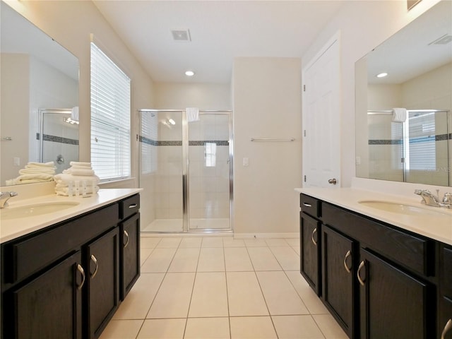 bathroom featuring tile patterned floors, vanity, and walk in shower