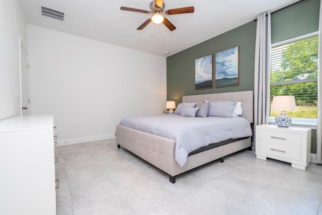 bedroom with ceiling fan and a textured ceiling