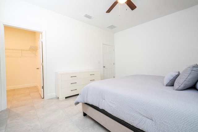 bedroom with a spacious closet, a closet, and ceiling fan