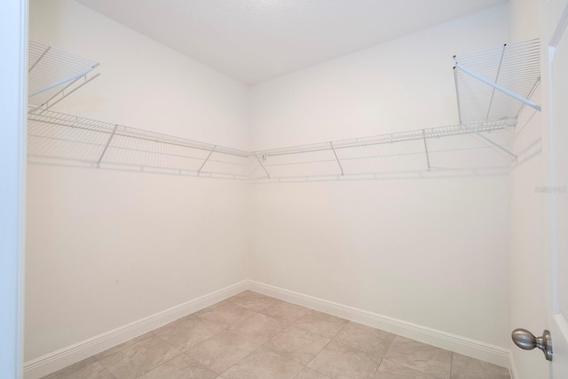 spacious closet featuring light tile patterned floors