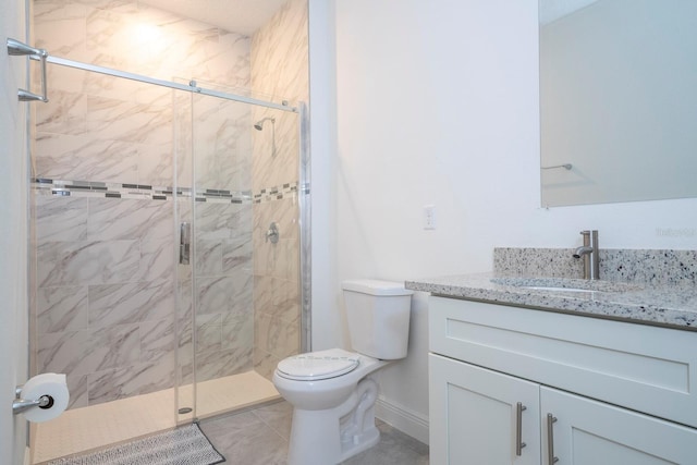 bathroom with tile patterned flooring, a shower with door, vanity, and toilet