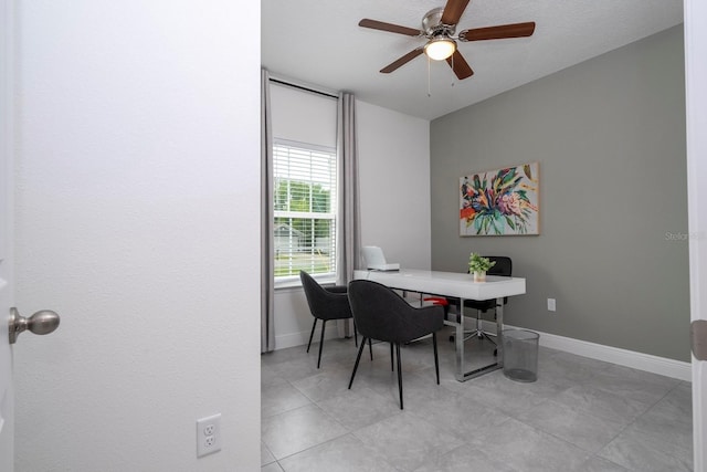 home office featuring ceiling fan, light tile patterned flooring, and a textured ceiling