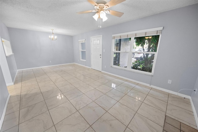 unfurnished room featuring ceiling fan with notable chandelier and a textured ceiling