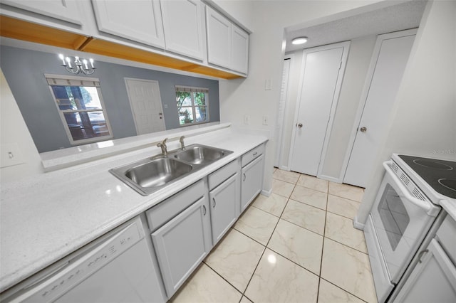 kitchen featuring sink, white appliances, and a notable chandelier