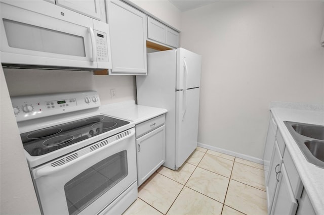 kitchen featuring white cabinetry, white appliances, sink, and light tile patterned floors