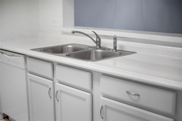 kitchen with white cabinets, sink, and white dishwasher