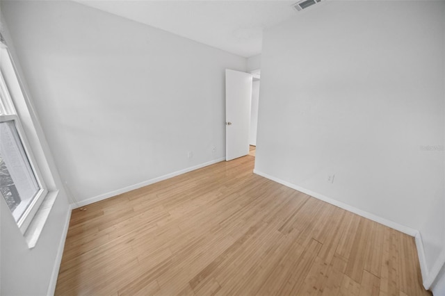 unfurnished room with light wood-type flooring