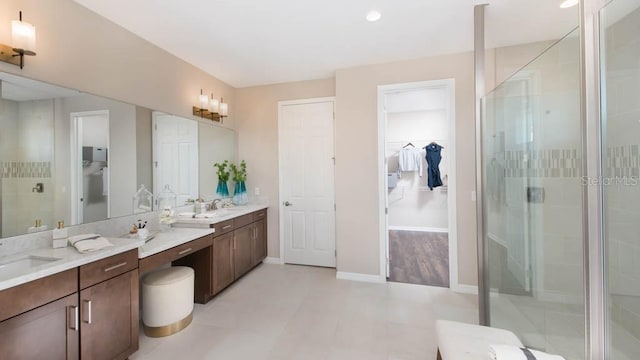 bathroom featuring vanity and a shower with shower door