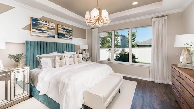 bedroom with a chandelier, dark hardwood / wood-style floors, a raised ceiling, and ornamental molding