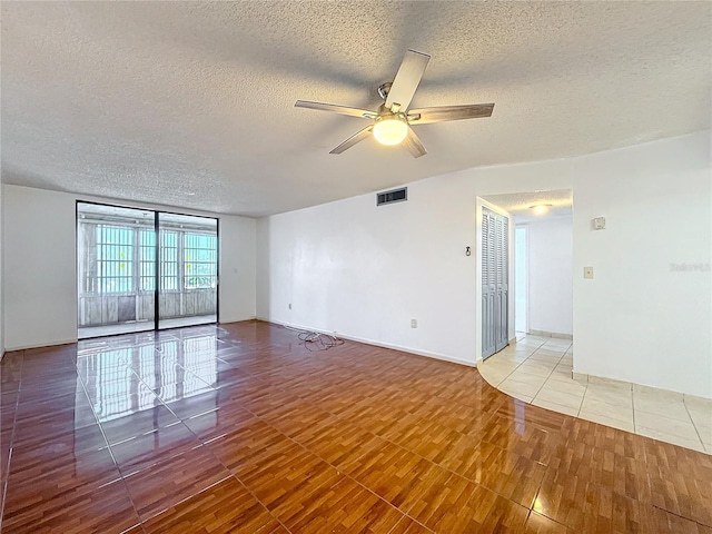 tiled spare room featuring ceiling fan and a textured ceiling